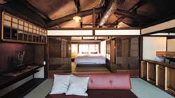 「閑月庵新豊」の客室。建物は、江戸時代末期に建てられたもの。この建物を支える大きな梁などから、ここで刻まれてきた物語を知ることができる