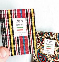 豆本のサイズは、縦：約75mm×横：約55mm×幅：約6mmで、手のひらに収まる。中東イランの首都・テヘランとエスファハーンの旅豆本。表紙には、現地で手に入れたイラン製の布を使用